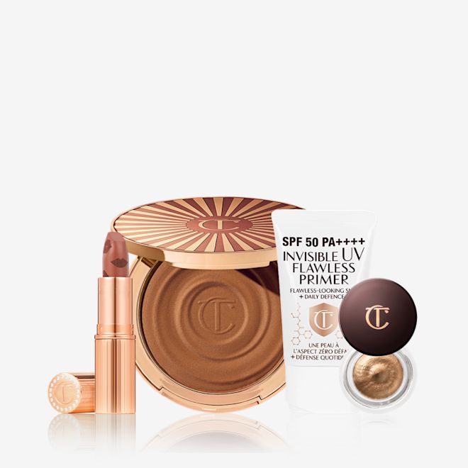 Summer Glow Look Feeling Kit An open nude terracotta lipstick in golden-coloured packaging, open cream bronzer compact in a dark brown shade, SPF-infused primer in white packaging, and cream eyeshadow in a dark gold shade with a dark brown lid.