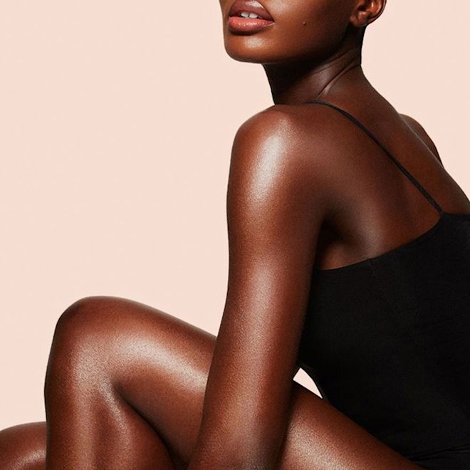 Supermodel Body on deep-tone model Model wearing body foundation and body makeup for glowing, flawless-looking skin