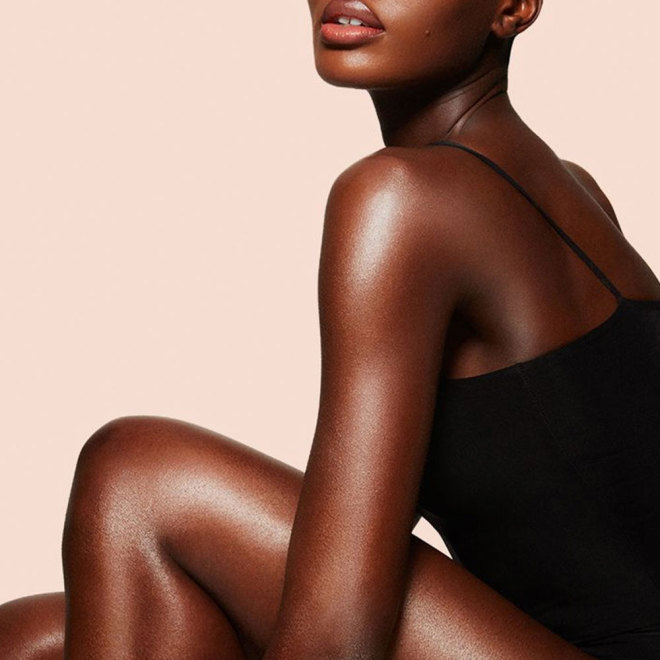 Model wearing body foundation and body makeup for glowing, flawless-looking skin