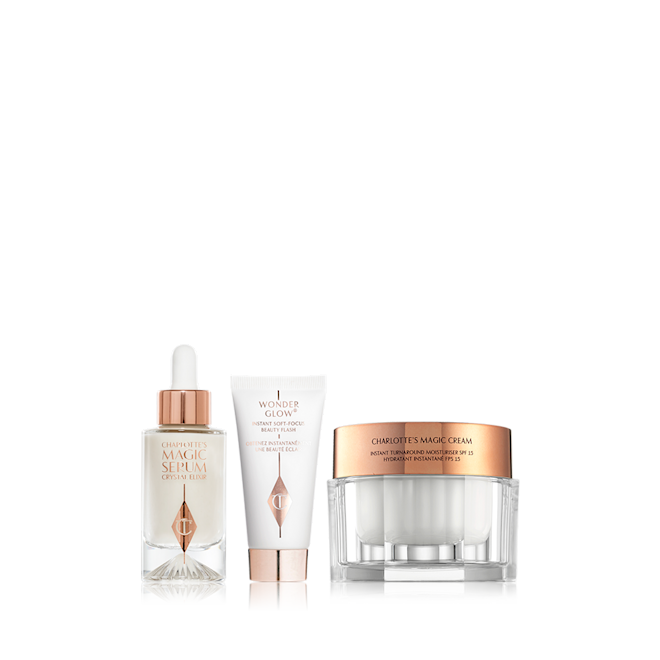 Beauty Secrets Glowing Skin Kit closed Luminous pearly-coloured serum in a glass bottle with a white and gold-coloured dropper lid, primer in a white tube with a gold-coloured lid, and pearly-white face cream in a glass jar with a gold-coloured lid.