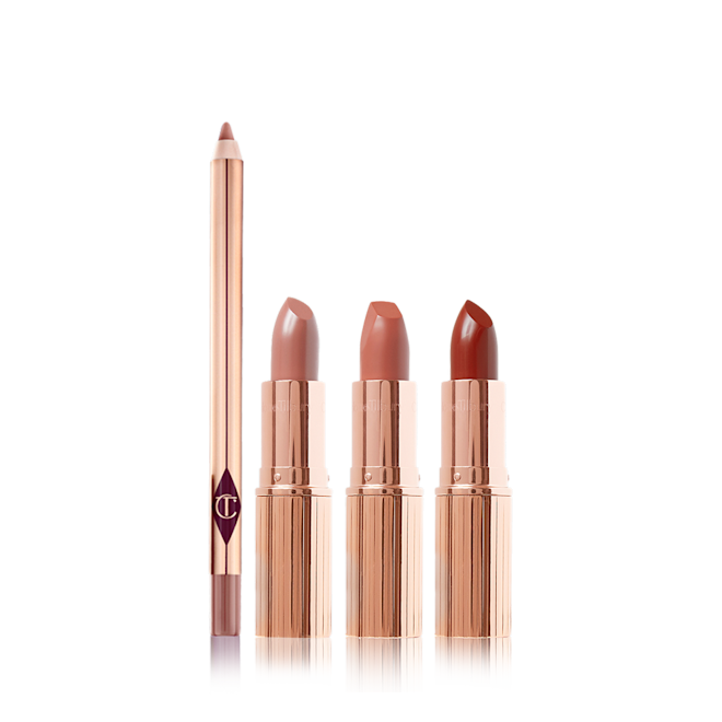 Super Nudes Lip Kit open An open lip liner pencil in a dark brown-beige shade with three open, nude lipsticks in cool-beige, nude peach, and nude brown-red, all four in gold-coloured packaging.