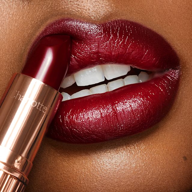 Night Crimson lip close up Dark-haired model wearing Night Crimson deep satin-finish red lipstick