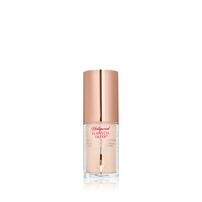 A closed glow-boosting primer in a glass bottle with a rose gold-coloured lid. 