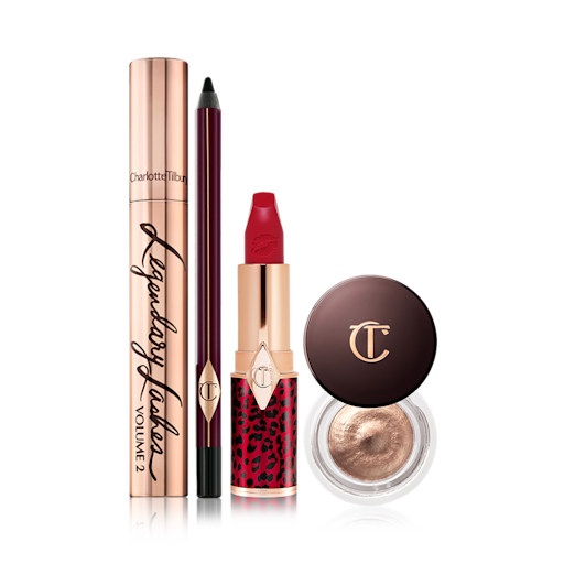 Mesmerising Holiday Eye and Lip Look displayed Black mascara in a gold-coloured tube, eyeliner pencil in a black colour, bold red lipstick, and cream eyeshadow in a petite pot with a dark brown-coloured serum.