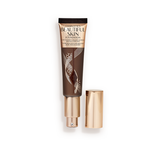 Beautiful Skin Foundation in Shade 17N open An open foundation wand in gold packaging with a pump dispenser and a black-brown-coloured body to show the shade of the foundation inside.