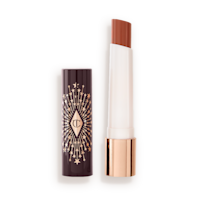 hyaluronic Happikiss in Happipeach lid removed An open lipstick lip balm in a sheer peachy-nude shade, in white and gold tube with a black-coloured lid with gold sparkles all over it.