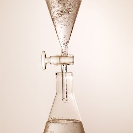 Hyaluronic Acid being tested Two laboratory apparatus with a clear hyaluronic acid inside them for testing purpose, which will be used for different skincare products.