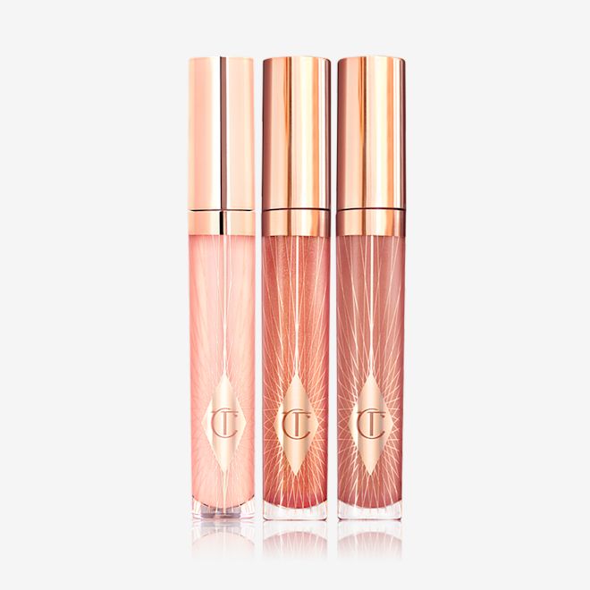 Collagen Lip Bath trio closed Three lip glosses in shades of light pink, coral-peach, and brown-pink in glass tubes with gold-coloured lids.