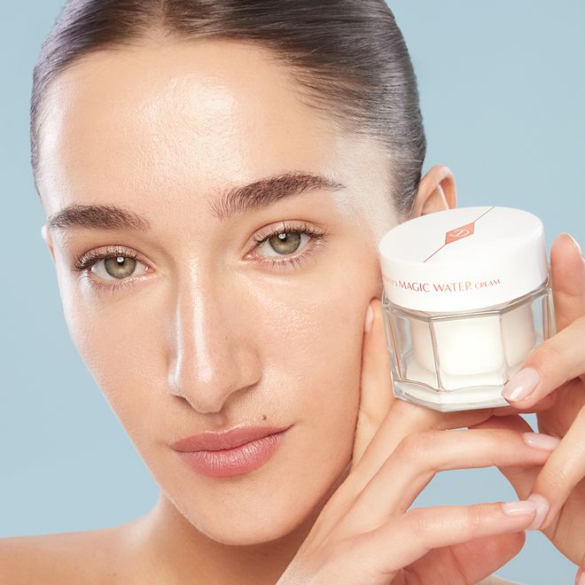 Bella Tilbury holding the NEW! Magic Water Cream Bella Tilbury holding the NEW! Magic Water Cream on a blue background