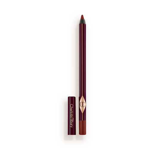 Eyeliner in Walk of No Shame open An eyeliner pencil in a berry-pink shade with its lid next to it.