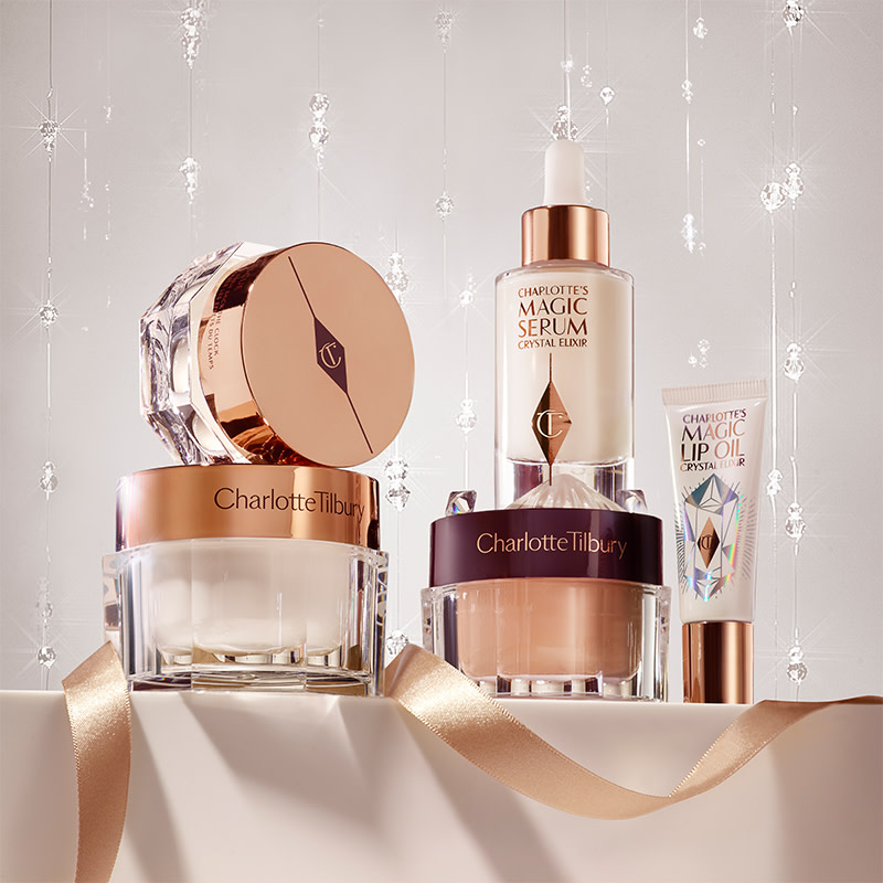Pearly-white face cream, copper-coloured night cream, and dark champagne eye cream, all in glass jars with a luminous, ivory-coloured face serum in a glass bottle with a dropper lid, and an eye serum in a white and gold tube.