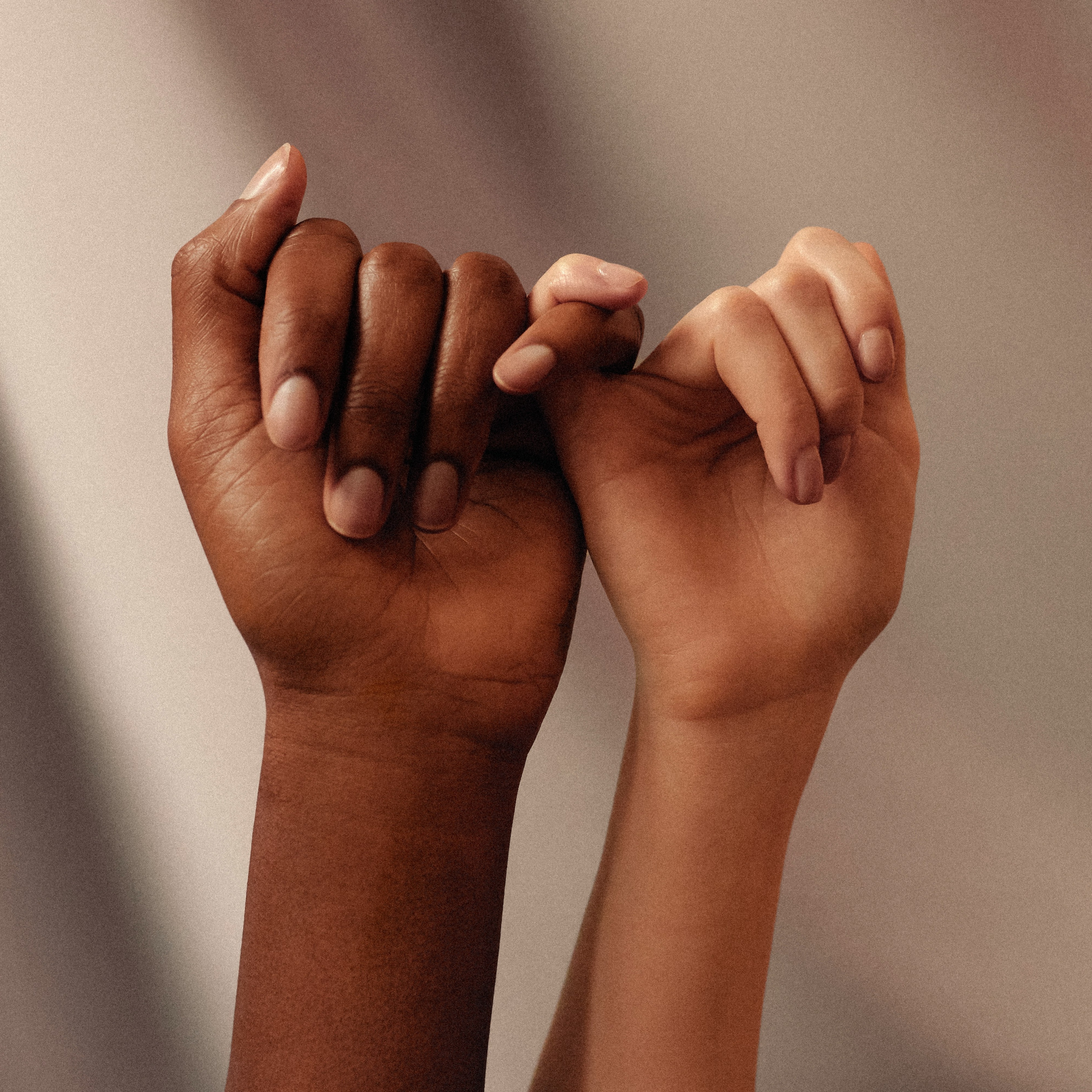 Two people's hands interlocked showing human connection