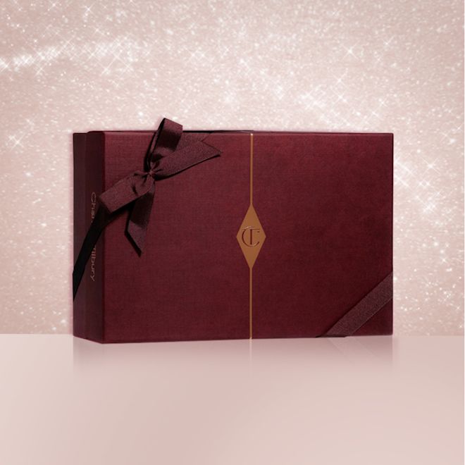 Mystery Box banner A dark crimson-coloured gift box with a matching bow on it and the CT logo printed on the middle of the box.