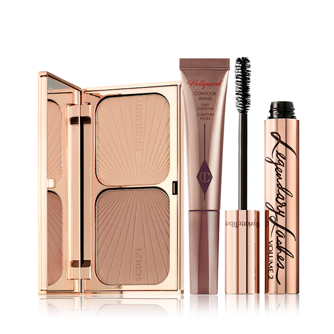 Red Carpet Makeup Kit An open duo contour palette for light to medium skin tone, a medium-brown liquid contour wand, and a black mascara in golden packaging with its applicator next to it.