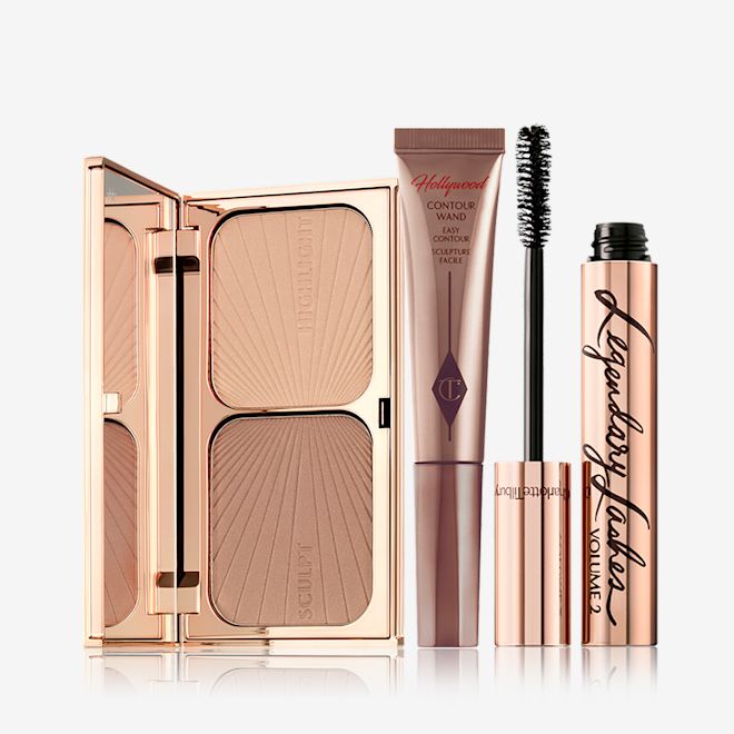 Red Carpet Makeup Kit An open duo contour palette for light to medium skin tone, a medium-brown liquid contour wand, and a black mascara in golden packaging with its applicator next to it.