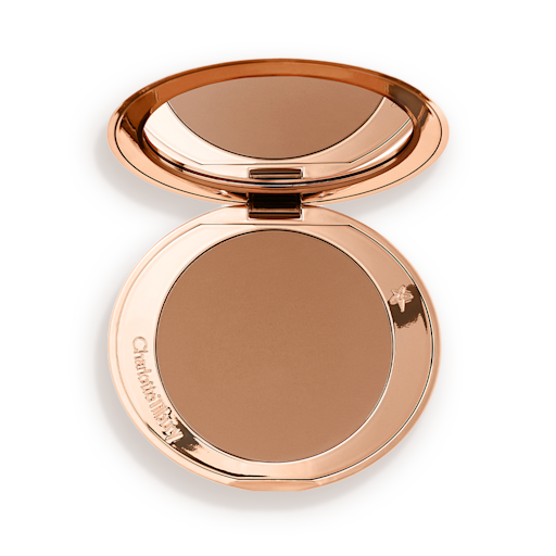 Airbrush Bronzer in Medium open An open mirrored-lid bronzer compact in a medium-brown shade.
