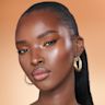 Quick & Easy Instant 5 Minute Golden Glow Look on deep-tone model Deep-tone brunette model with brown eyes wearing shimmery bronze eyeshadow with black eyeliner, nude rose matte lipstick with nude rose blush, and glowy opal-coloured highlighter for a flawless, glowy look.