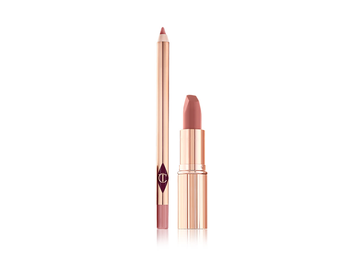 Pillow Talk Lip Kit open An open nude pink lip liner pencil with an open nude pink matte lipstick, both in golden-coloured packaging.