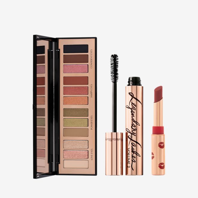 Smokey Eyes Lucky Lips Kit open An open, 12-pan eyeshadow palette in matte and shimmery shades beige, pink, silver, green, brown, pink, orange, red, black, black mascara in gold-coloured tube, and maroon lipstick in gold-coloured tube.