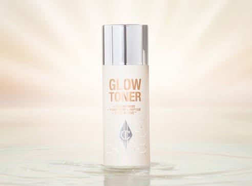 Glow Toner closed travel-size A travel-size, clear bottle filled with luminous, cream-coloured watery toner with a silver-coloured lid.