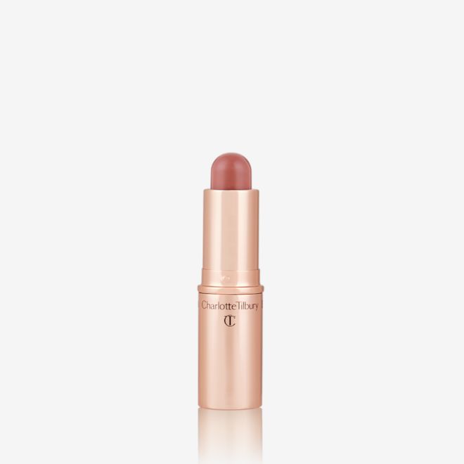 Quick & Easy Instant 5 Minute Date Night Look lip and cheek stick open An open, lip and cheek colour stick in a glowy soft pink shade in a golden-coloured tube.