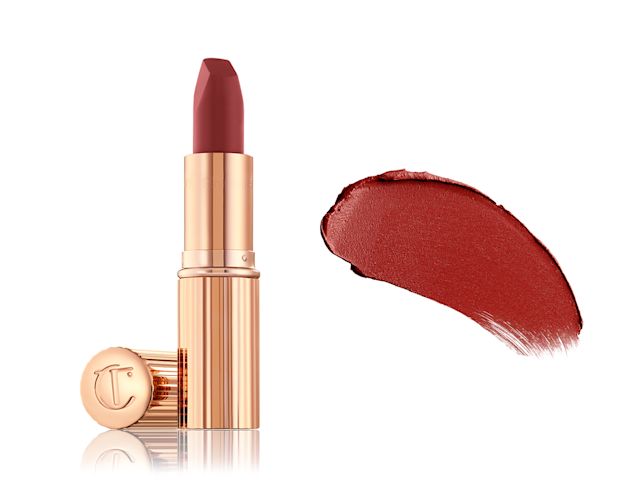 Matte Revolution Walk of No Shame with swatch An open berry-rose lipstick in a gold colour-scheme with its lid next to it along with its swatch on the right side.