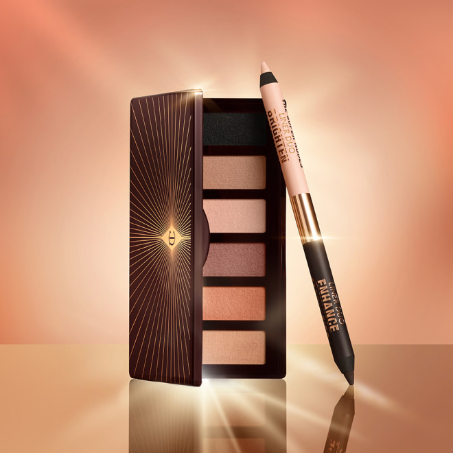 A double-ended eyeliner pen in beige and black shades with an open, mirrored-lid six-pan eyeshadow palette with matte eyeshadows in brown, peach, and beige shades