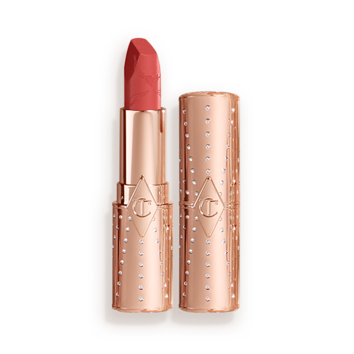 Look of Love Matte Revolution Lipstick in Mrs Kisses open An open, golden peachy-pink lipstick in a metallic, golden-coloured tube with its lid next to it.