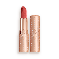 Look of Love Matte Revolution Lipstick in Mrs Kisses open An open, golden peachy-pink lipstick in a metallic, golden-coloured tube with its lid next to it.