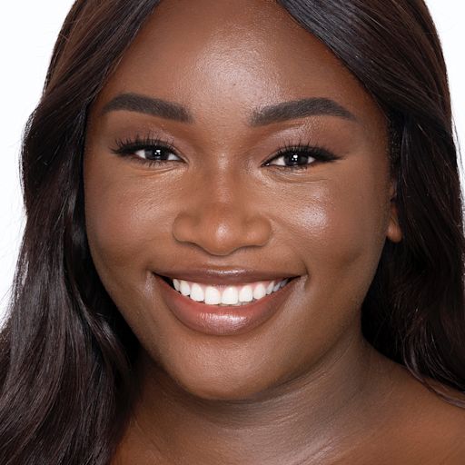 Beautiful Skin Foundation in 14N on a deep-tone model Deep-tone brunette model with brown eyes wearing nude pink lipstick with a skin-like foundation with a flawless, dewy finish.