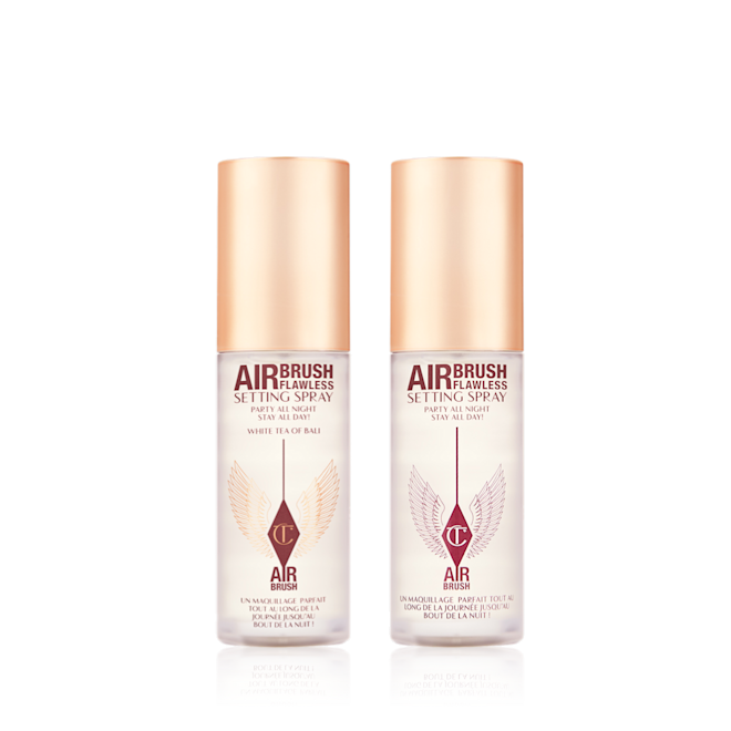 Airbrush Flawless Setting Spray Duo travel-size closed Two, identical, mini, setting sprays in clear bottles with gold-coloured lids.