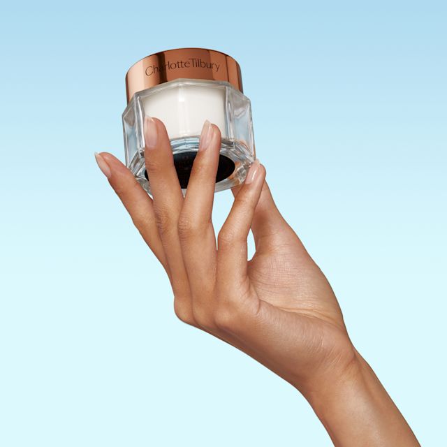 Magic Cream close up Model holding Charlotte's Magic Cream immediate skin revival moisturiser