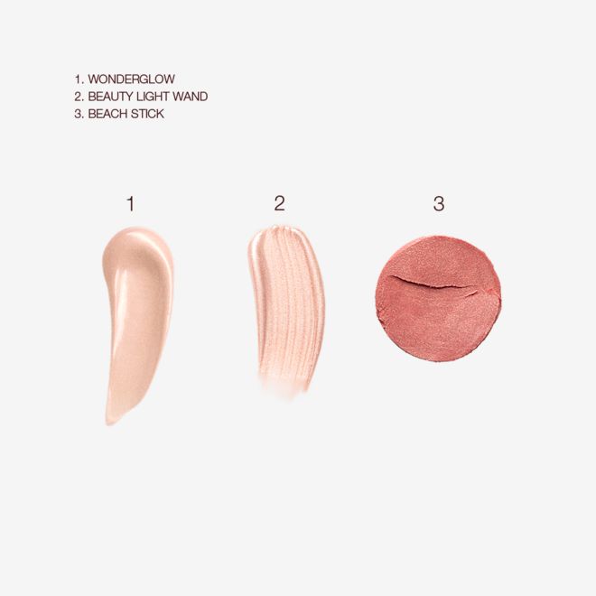 Happy Beauty Glow Kit swatches Swatches of an illuminating primer ina light-beige colour, a rose-gold liquid highlighter, and a terracotta powder blush.