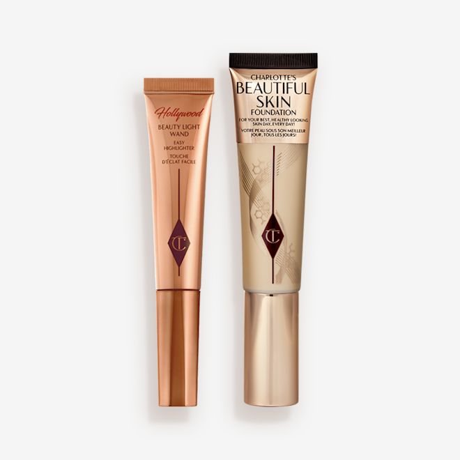 Beauty Skin Foundation and beauty Light Wand closed Highlighter wand in light gold-coloured packaging with a foundation wand in gold packaging with a ashy brown-beige-coloured body to show the shade of the foundation inside, and a gold-coloured lid.