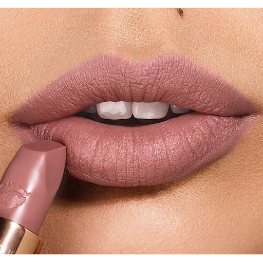 Matte Revolution in Very Victoria lips close-up Lips close-up of a light-tone model applying a matte lipstick in a taupe nude shade,