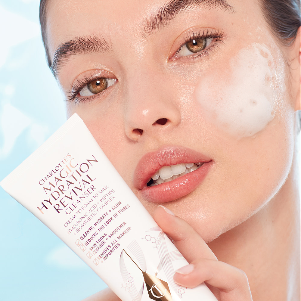 Model applying Charlotte's Magic Hydration Revival Cleanser foaming cleanser