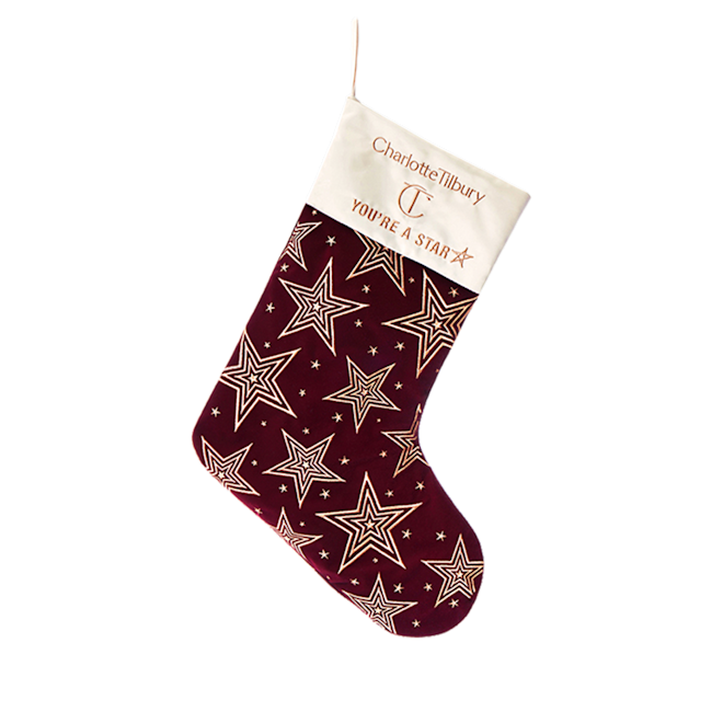 Holiday stocking A maroon-coloured holiday stocking with gold-coloured stars printed all over.