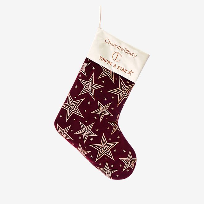 Holiday stocking A maroon-coloured holiday stocking with gold-coloured stars printed all over.