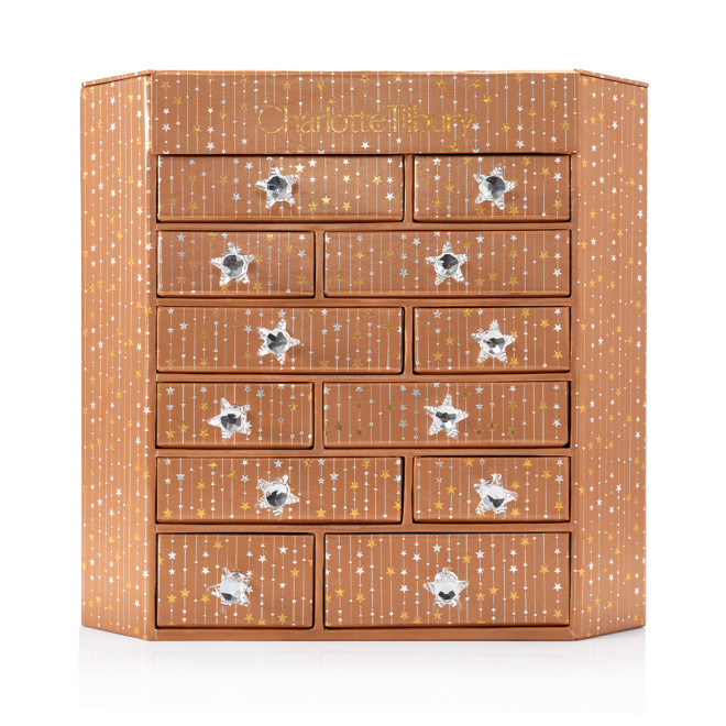 A golden-coloured chest with twelve drawers with shiny, silver-coloured star handles. 