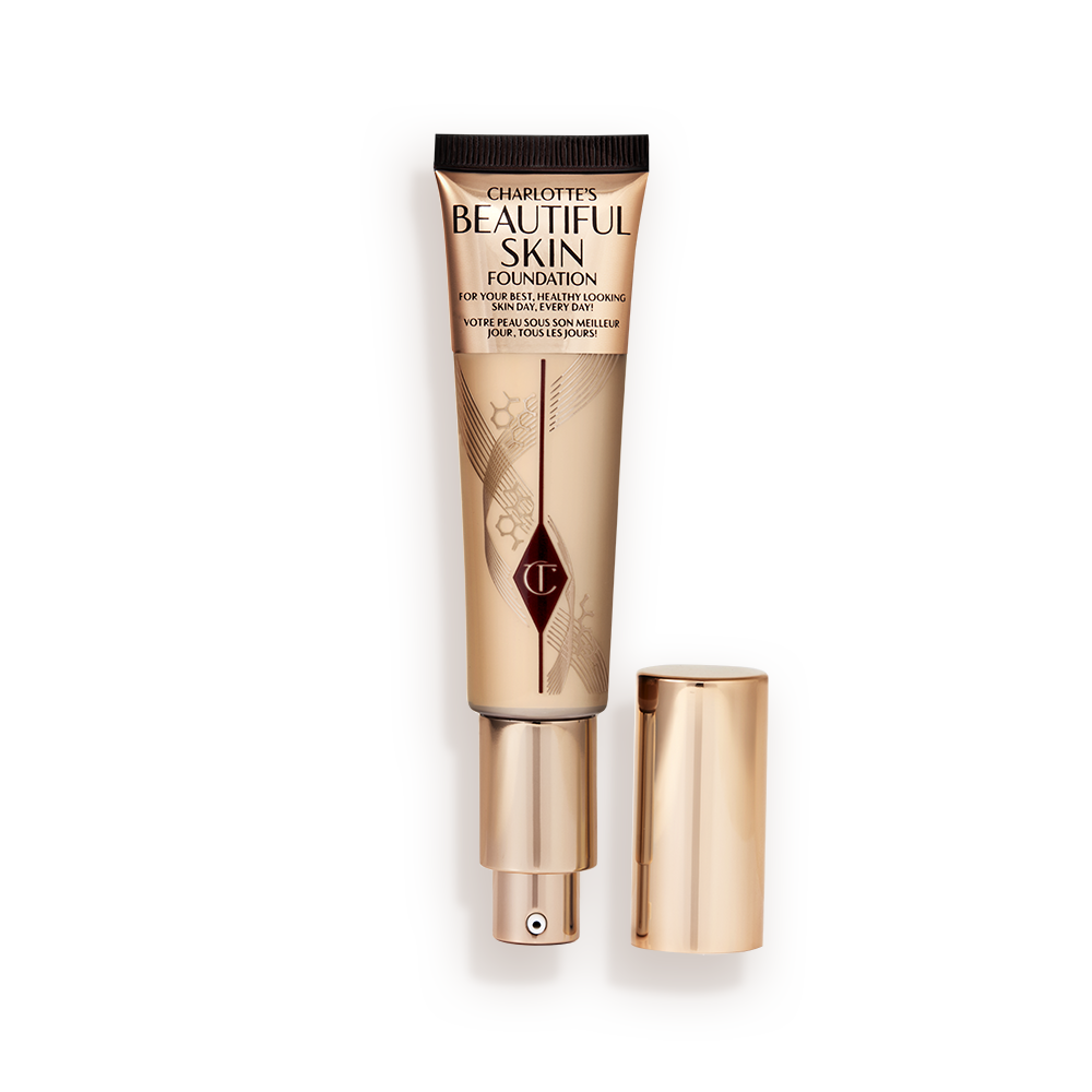 Beautiful Skin Foundation in 4N open An open foundation wand in gold packaging with a pump dispenser and a light-brown-coloured body to show the shade of the foundation inside.