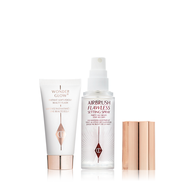 Ready Set Glow Makeup Travel kit Travel size primer in a white-coloured tube with rose-gold-coloured and a travel-size setting spray in a clear bottle with gold-coloured lid.