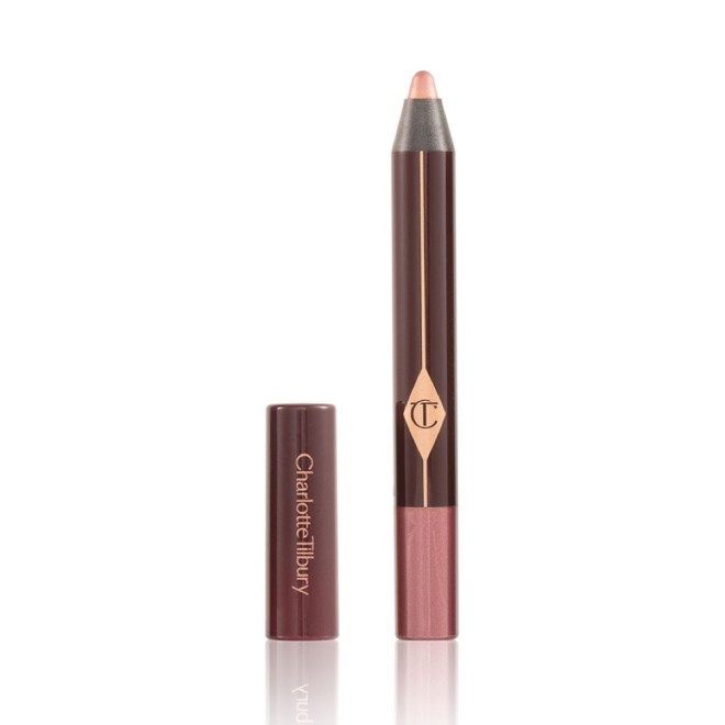 An open chubby eyeshadow stick in pink with rose gold sparkle with its lid next to it.