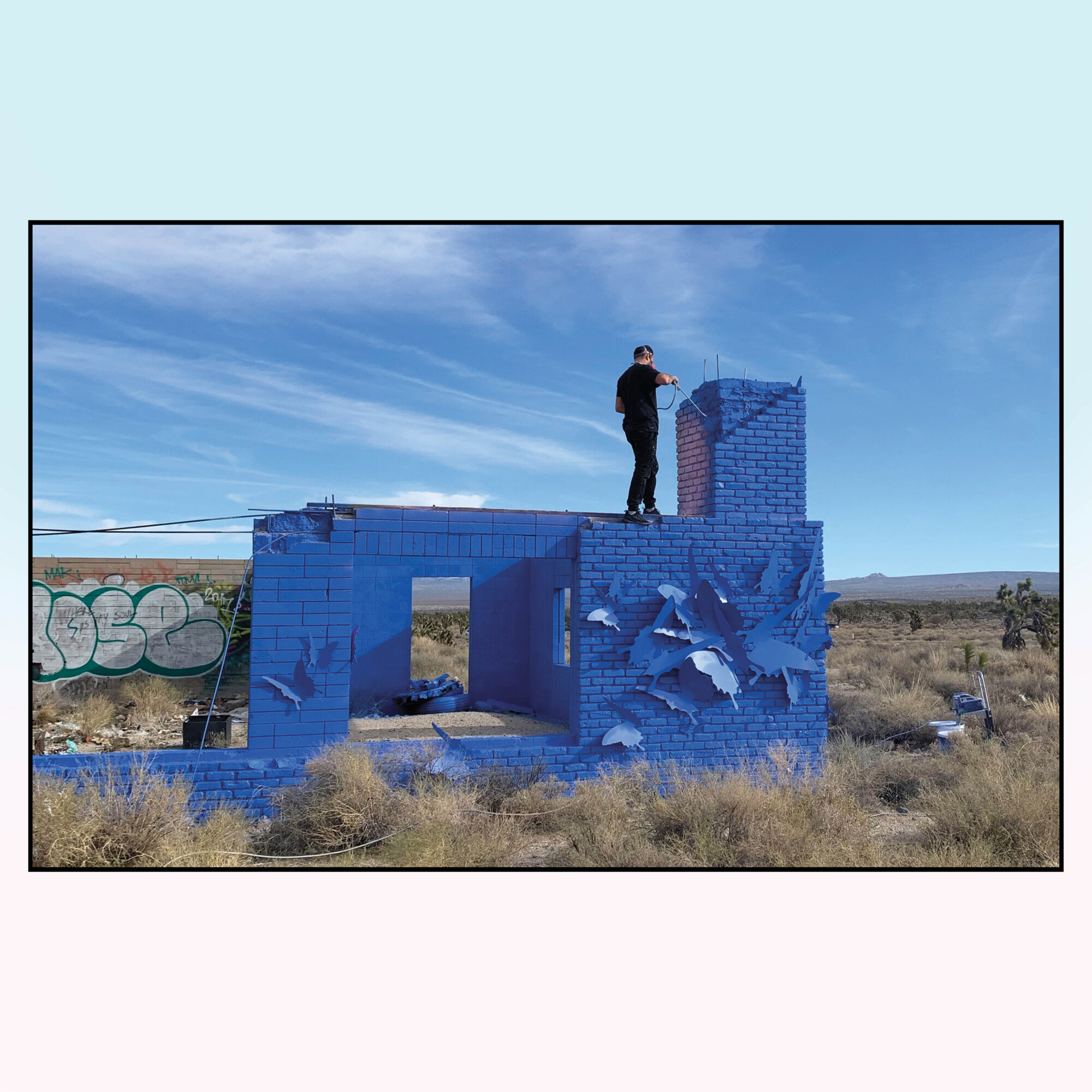 man on top of blue building