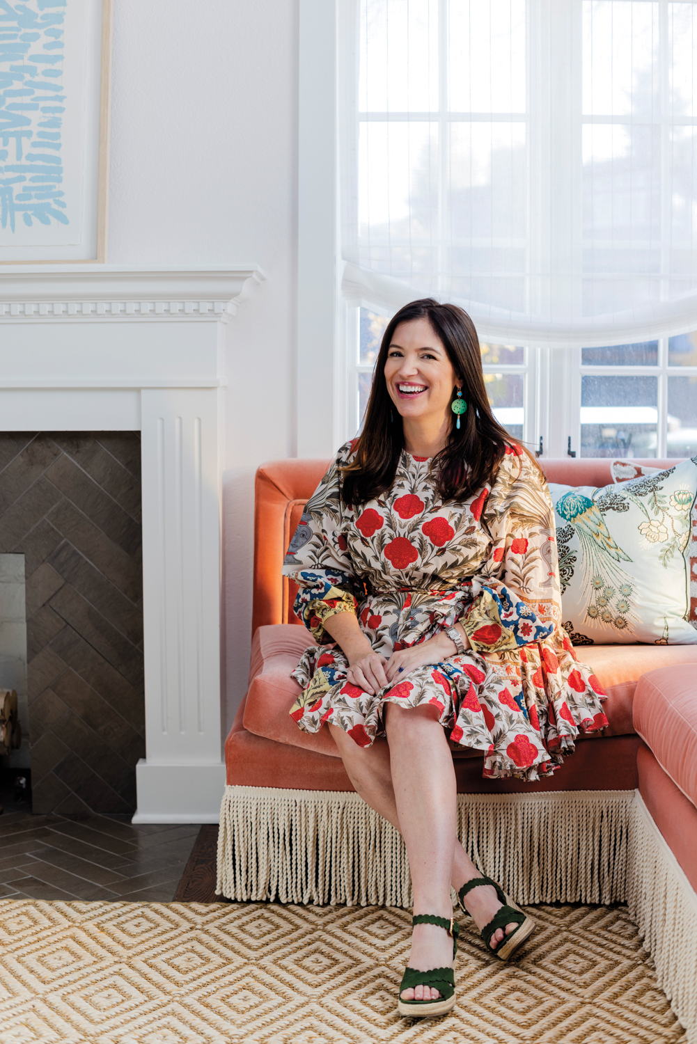Portrait of Jess Knauf sitting on a corner sofa.