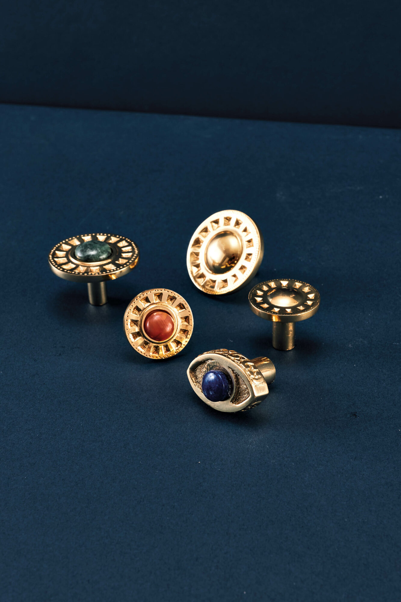 Cabinet pulls by Young Huh for Modern Matter shaped like ancient gold coins with gemstones