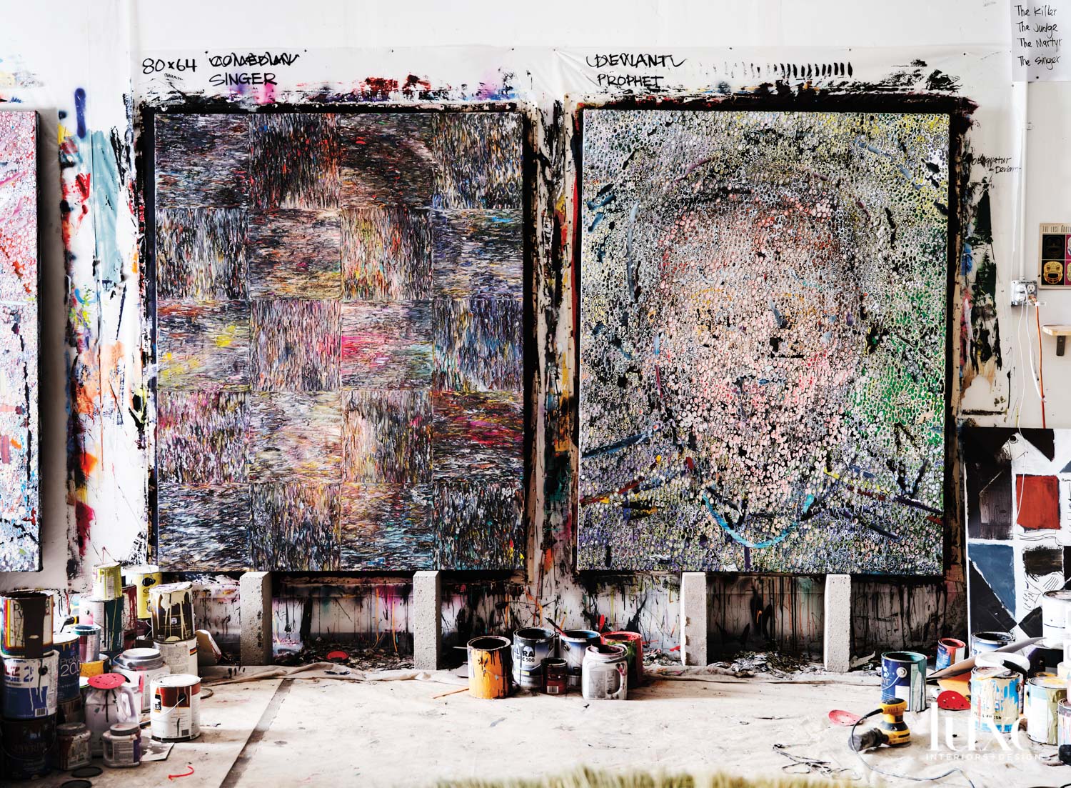 A pair of colorful artworks hang side by side.