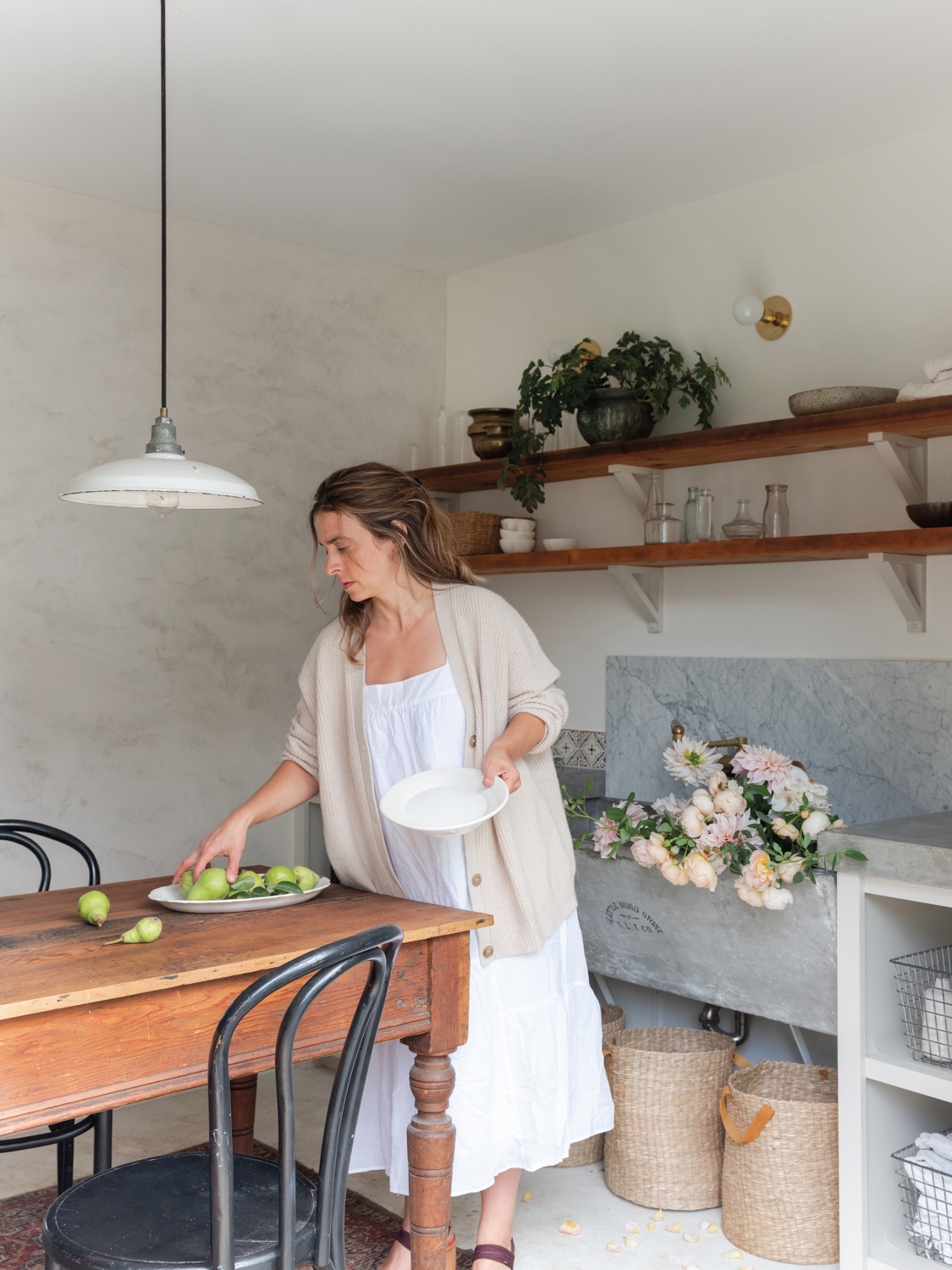 Florist Teressa Johnson prepping florals and other pieces for tablescape