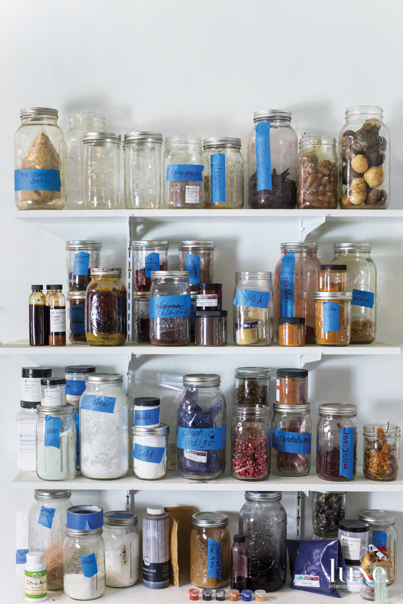 In Crawford's Fairfax studio, blue painter's tape is a fitting accent for mason jars of organic indigo, minerals and other pigments.