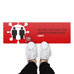 Rectangular floor sticker with a red background and the text "We will help keep you and your employees safe - 1m distance"