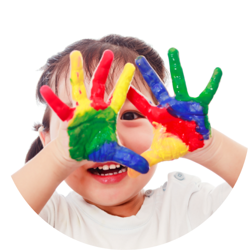 happy child with paint on hands from finger painting